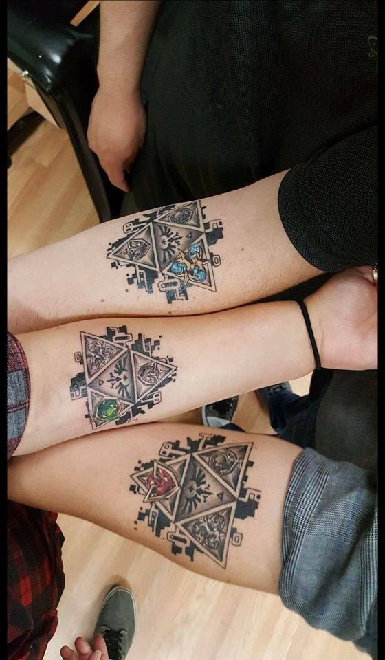 Matching best friends triforce tattoos on the arms