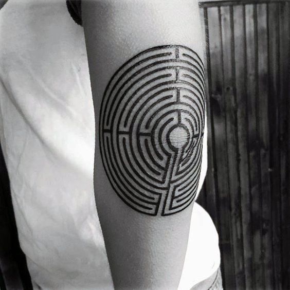 Maze tattoo on the left elbow