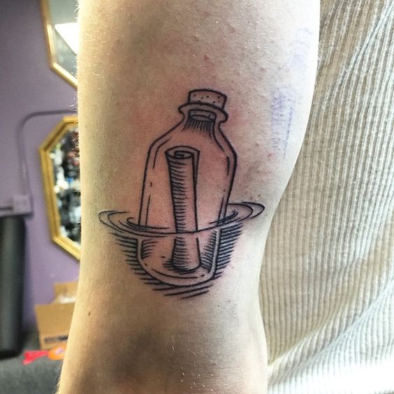 Message in a bottle tattoo on the left leg