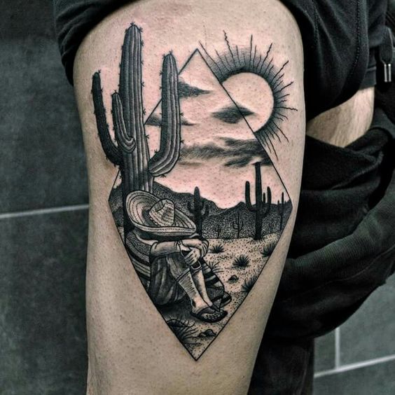 Mexican desert scenery tattoo on the right upper thigh