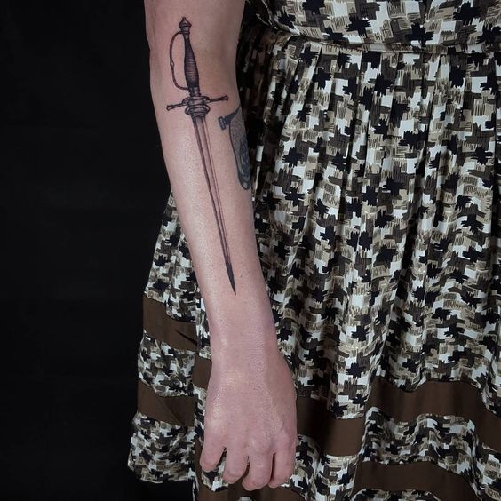 Mid sized sword tattoo on the right arm