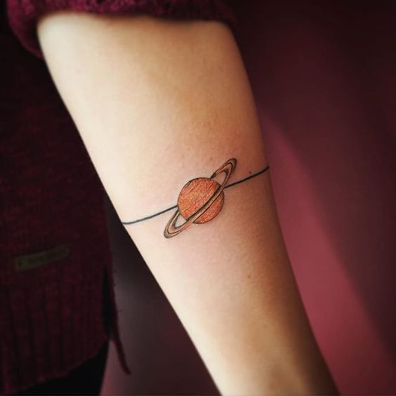 Mini saturn planet tattoo on the arm