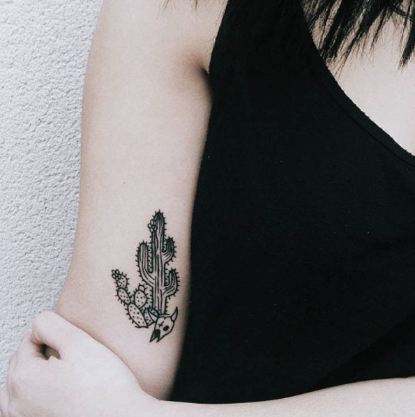Minimal cactus tattoo on the right inner arm