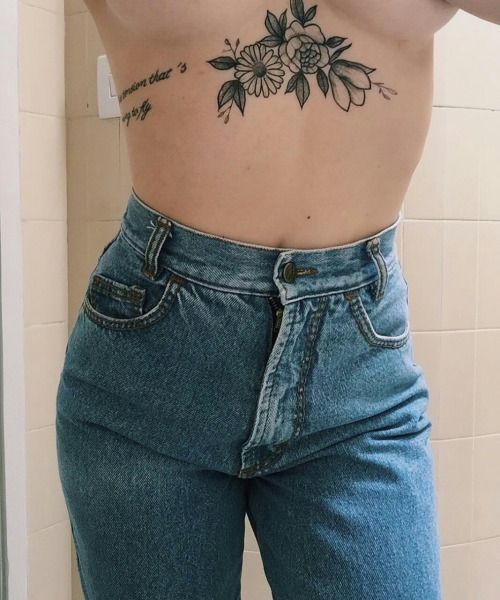 Monochrome black flower tattoo on the sternum