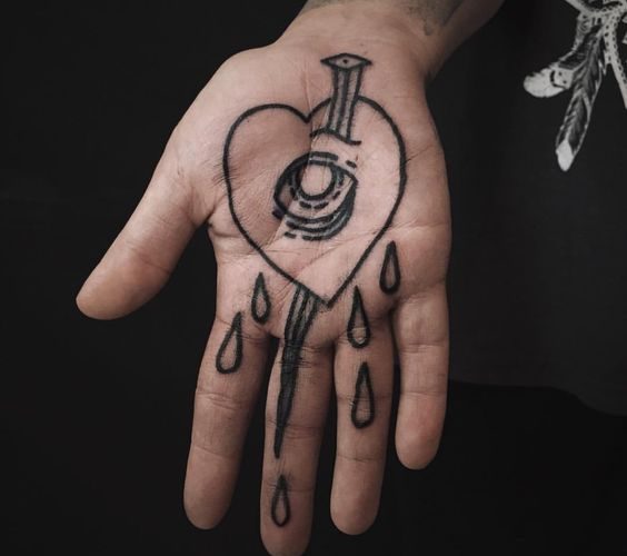 Nail stabbed and crying heart tattoo on the palm