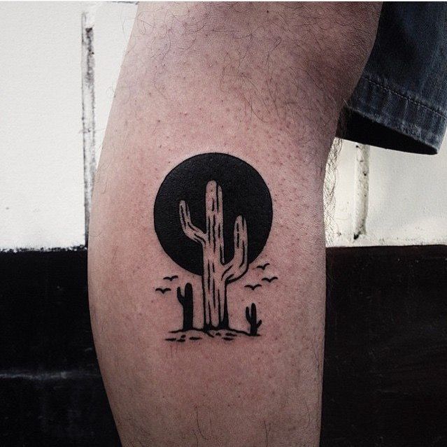 Negative space cactus and black sun tattoo