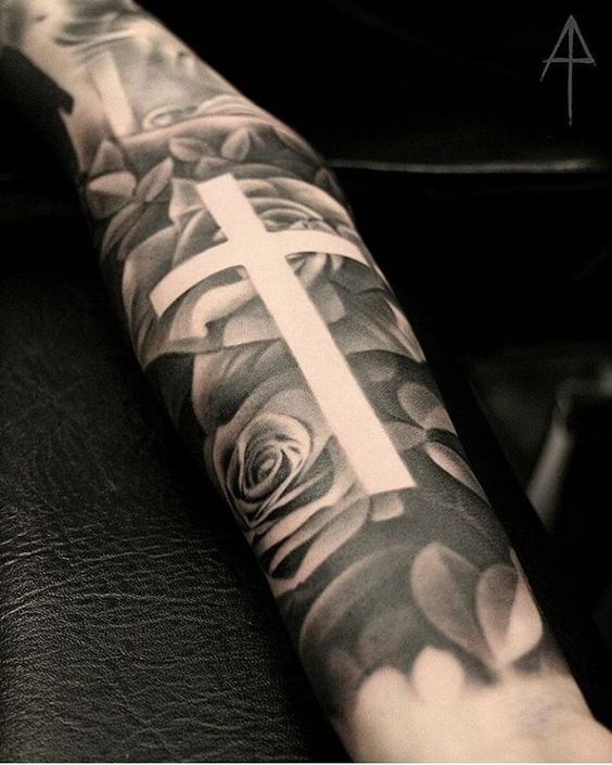 Negative space cross tattoo in a floral background