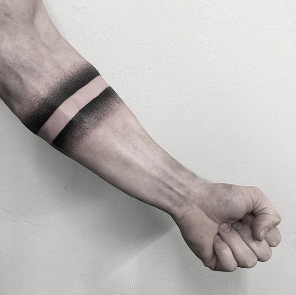 Negative space dotwork armband tattoo