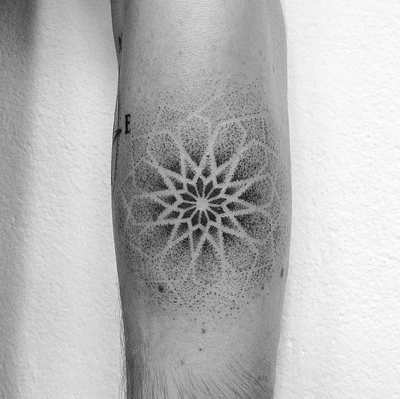 Negative space dotwork mandala tattoo