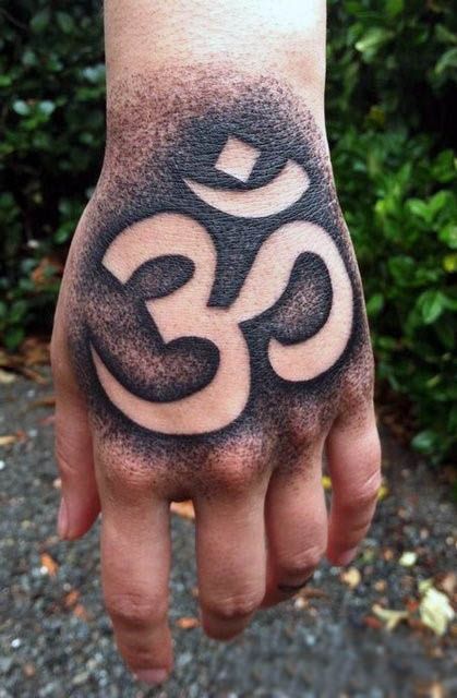 Negative space om symbol tattoo on the left hand