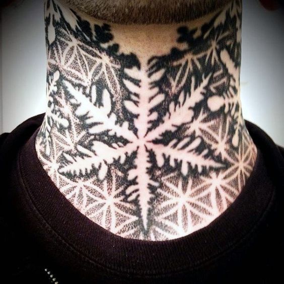 Negative space snowflake tattoo on the neck