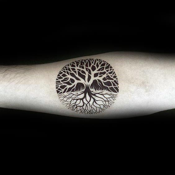 Negative space tree of life tattoo on the right arm