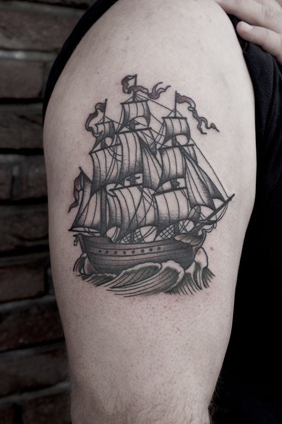 Neo traditional black three masted sailing vessel tattoo on the right bicep