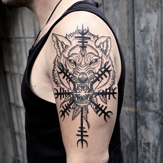 Nordic wolf with helm of awe tattoo on the left arm