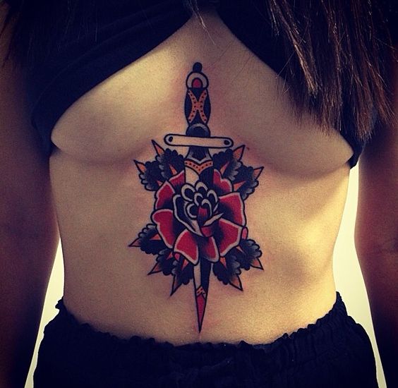 Old school dagger and rose tattoo on the breastbone
