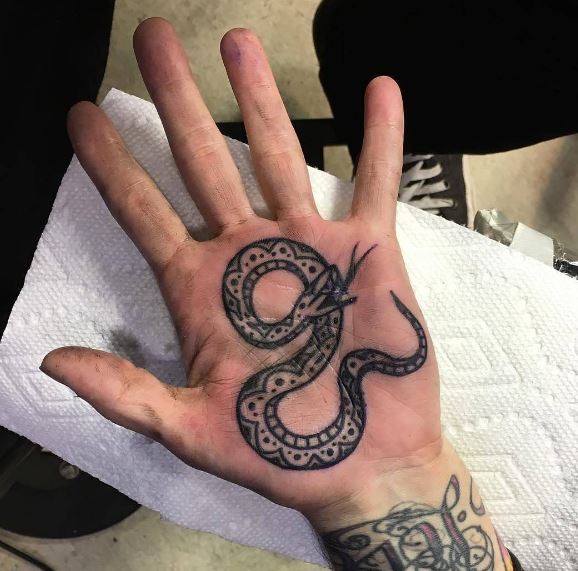 Old school snake tattoo on the left palm