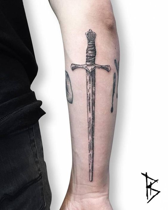 Old sword tattoo on the right forearm