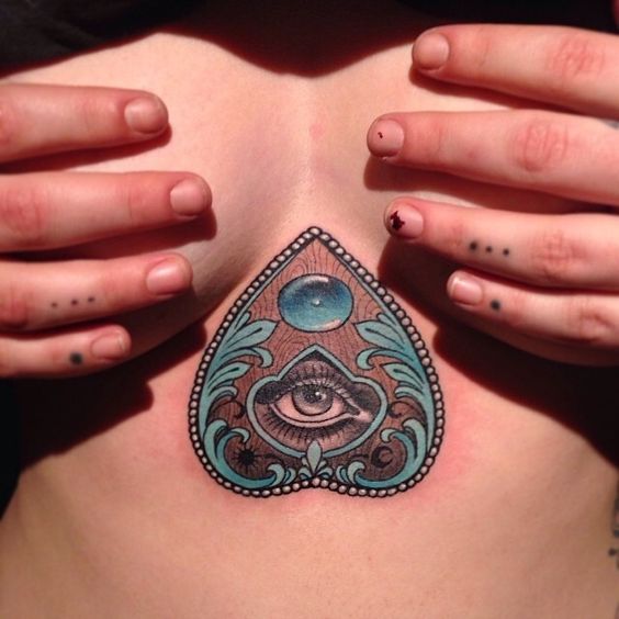 Ouija tattoo on the breastbone