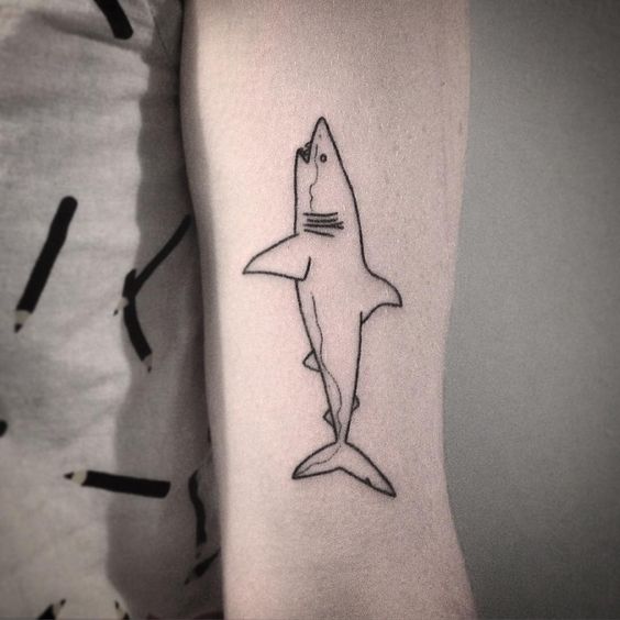 Outline black shark on the left upper arm