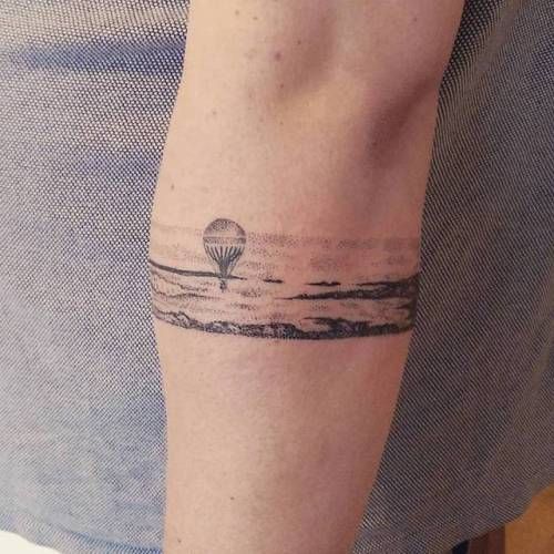 Over the hills landscape armband tattoo