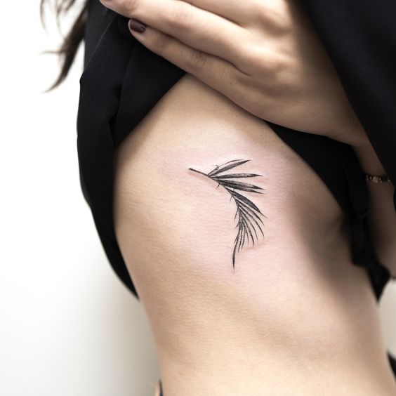 Palm leaf tattoo on the right rib cage