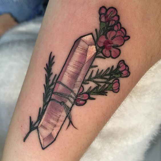 Pink quartz crystal tattoo with a flower