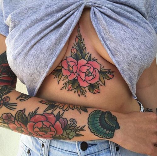 Pink rose tattoo on the sternum