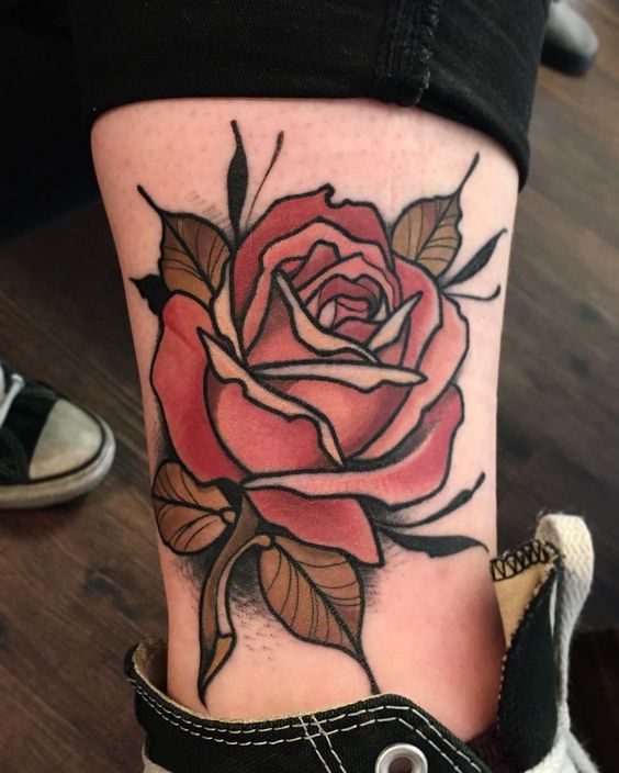 Pink traditional rose tattoo on the left inner ankle