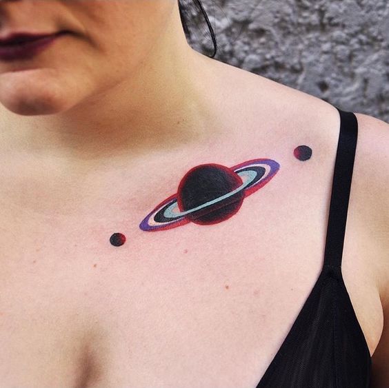 Planet saturn tattoo on the collarbone by marcin alexander surowiec