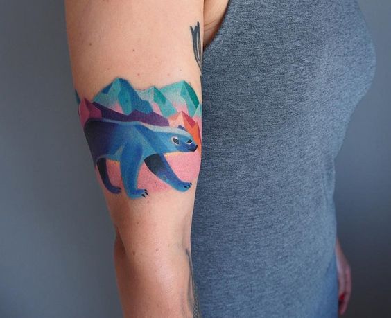 Polar bear and mountains tattoo on the right arm