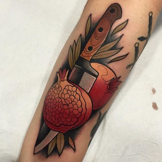 Pomegranate and knife neo traditional tattoo on the arm