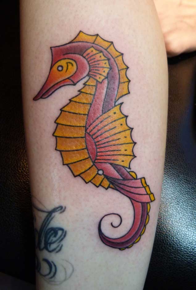 Red and yellow seahorse tattoo