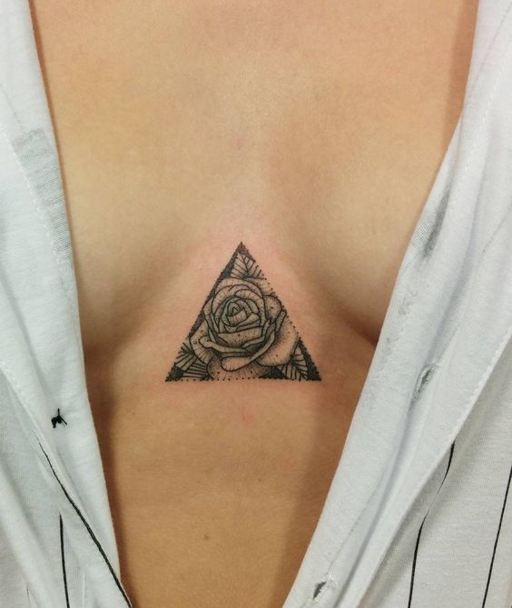 Rose in a triangle sternum tattoo