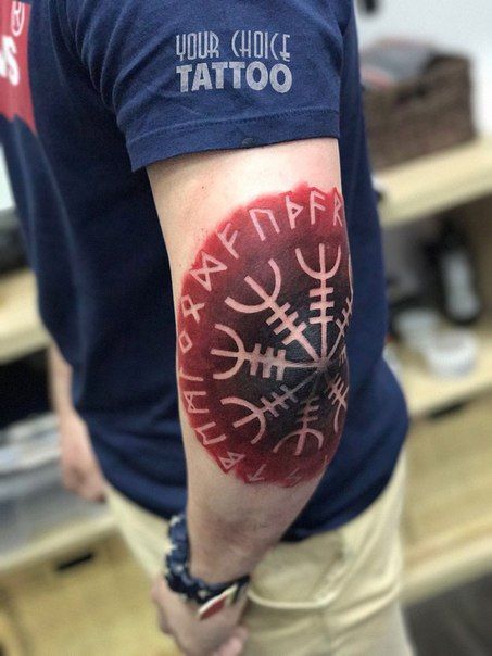 Runes and aegishjalmur tattoo on the elbow