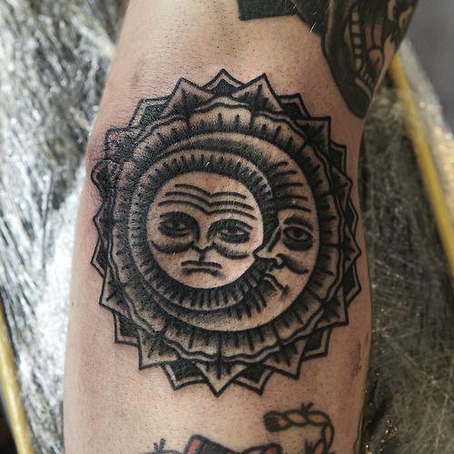 Sad moon and sun tattoo in black color on the arm