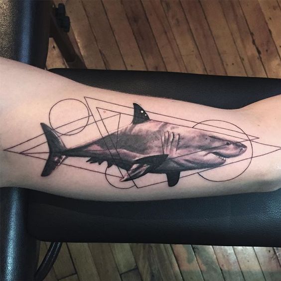 Shark and geometric shapes on the left arm