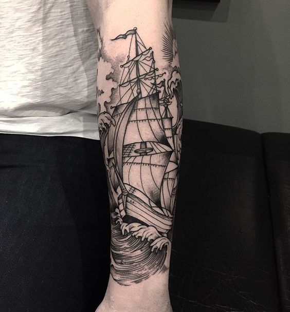 Ship and the tides tattoo on the left arm