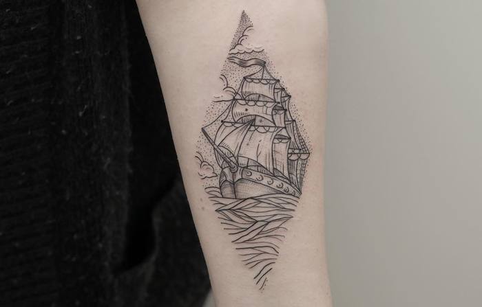 Ship in a rhombus dot work style tattoo