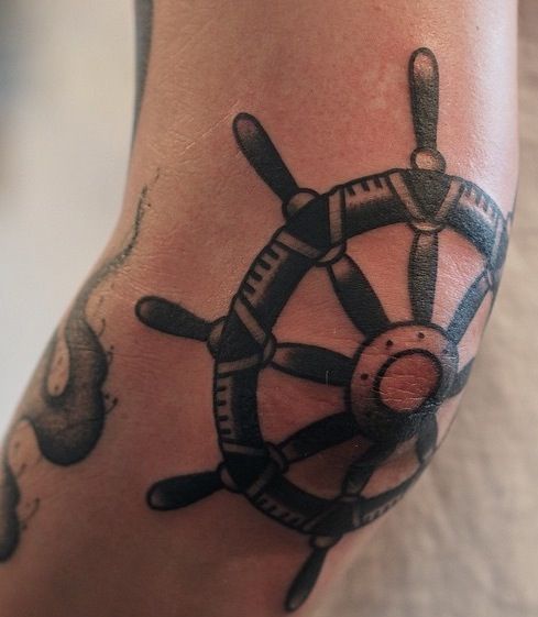 Ship wheel elbow tattoo