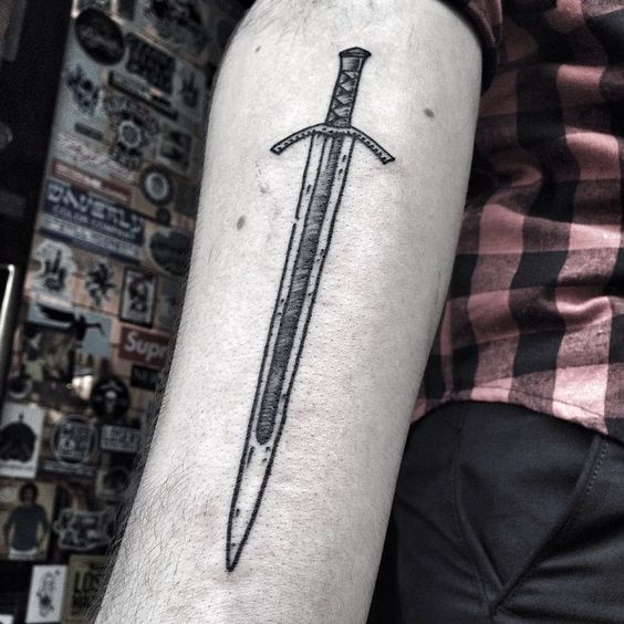 Simple sword tattoo on the right inner arm