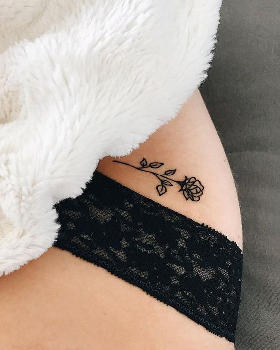 Small black rose tattoo on the hip