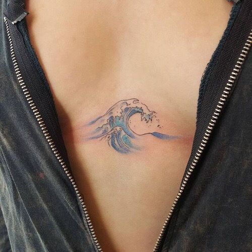 Small blue wave tattoo on the sternum