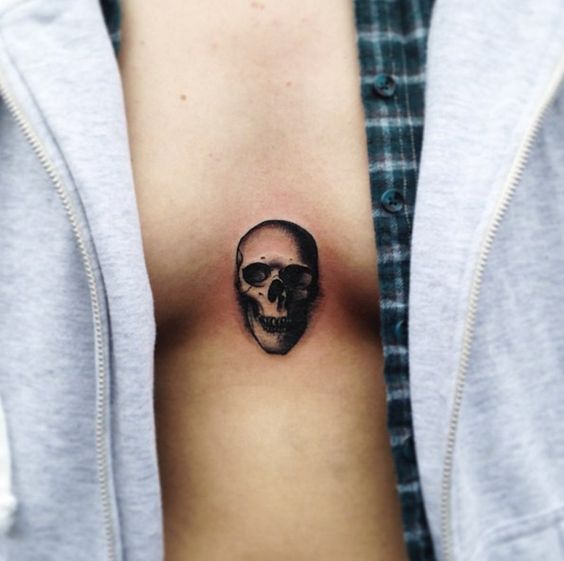 Small skull tattoo on the sternum