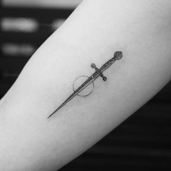 Small sword tattoo with a circle