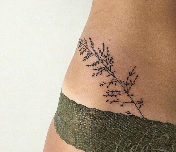 Small wildflower tattoo on the hip