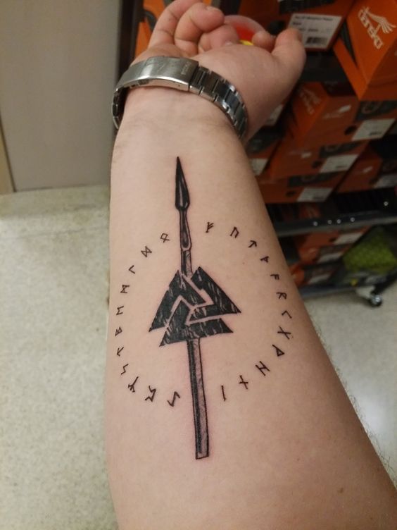 Spear valknut and runes tattoo on the right inner arm