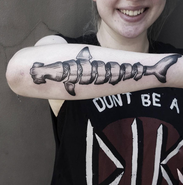 Spiraling hemmerhead shark tattoo on the right forearm