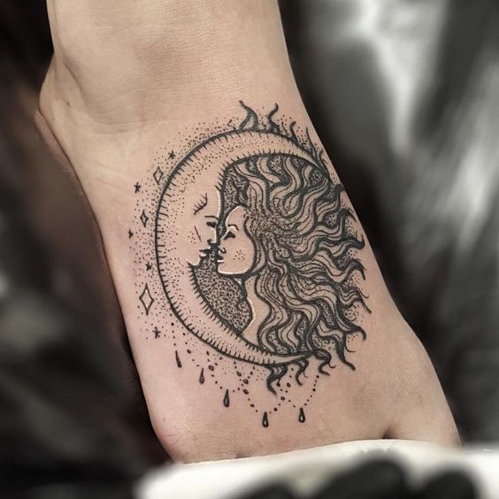 Sun and moon kiss tattoo on the right foot