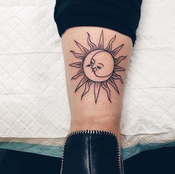 Sun and moon kissing tattoo on the left calf