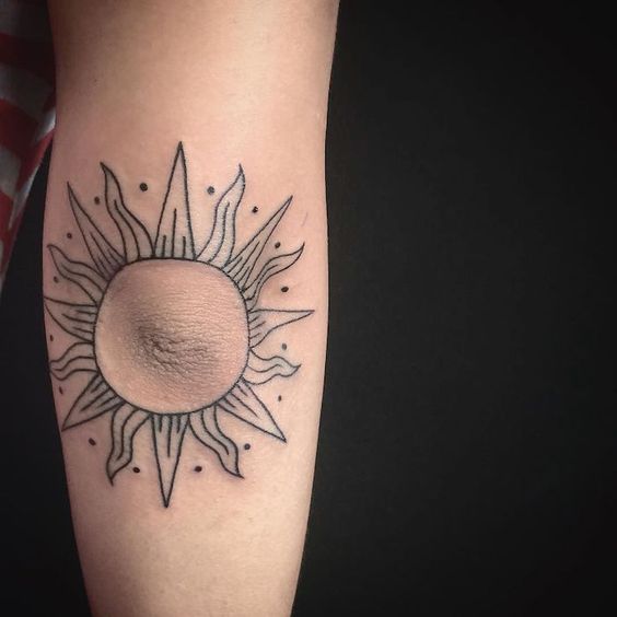 Sun tattoo around the elbow